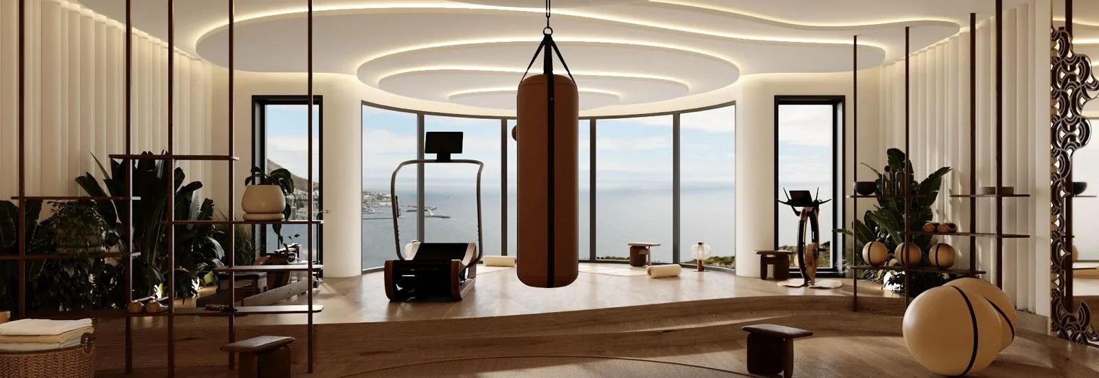 Salle de sport privée à Monaco avec vue mer, sac de frappe suspendu, tapis de course et design intérieur haut de gamme réalisée par Intérieurs à Croquer.