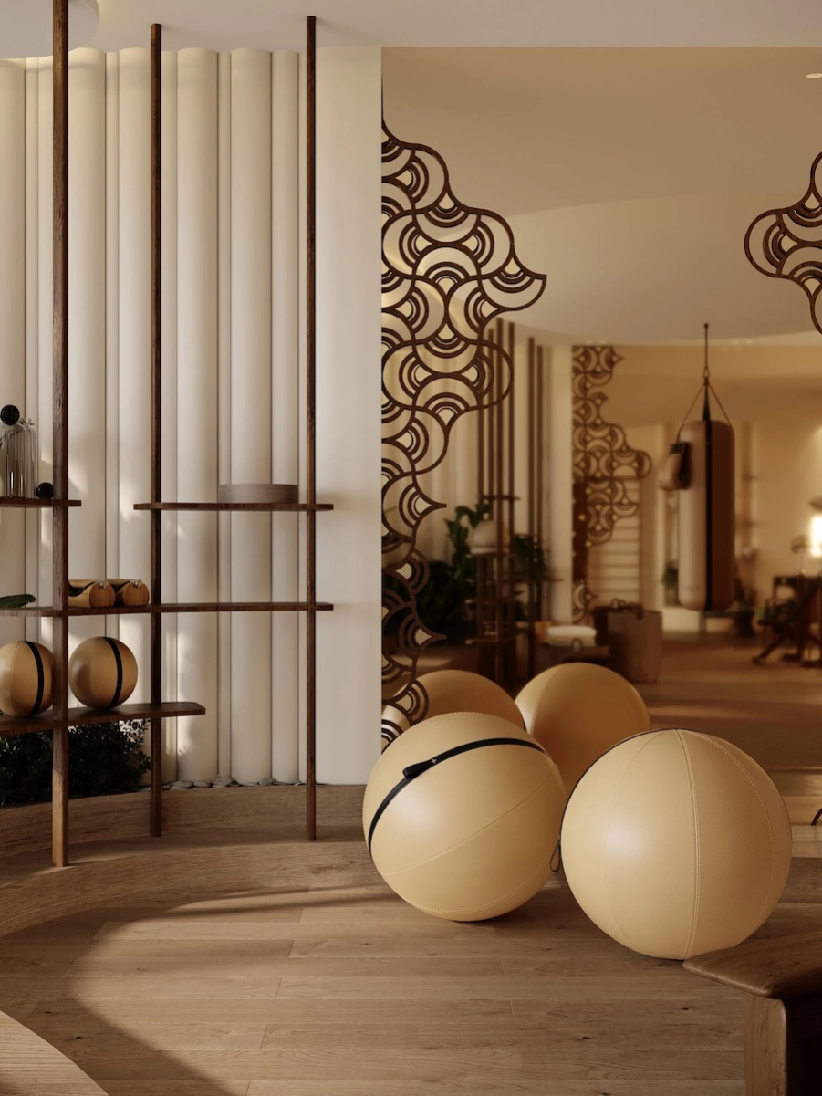 Détail d’un espace fitness privé à Monaco avec ballons d’entraînement, étagère design sur mesure, matériaux nobles et ambiance chaleureuse sur mesure.