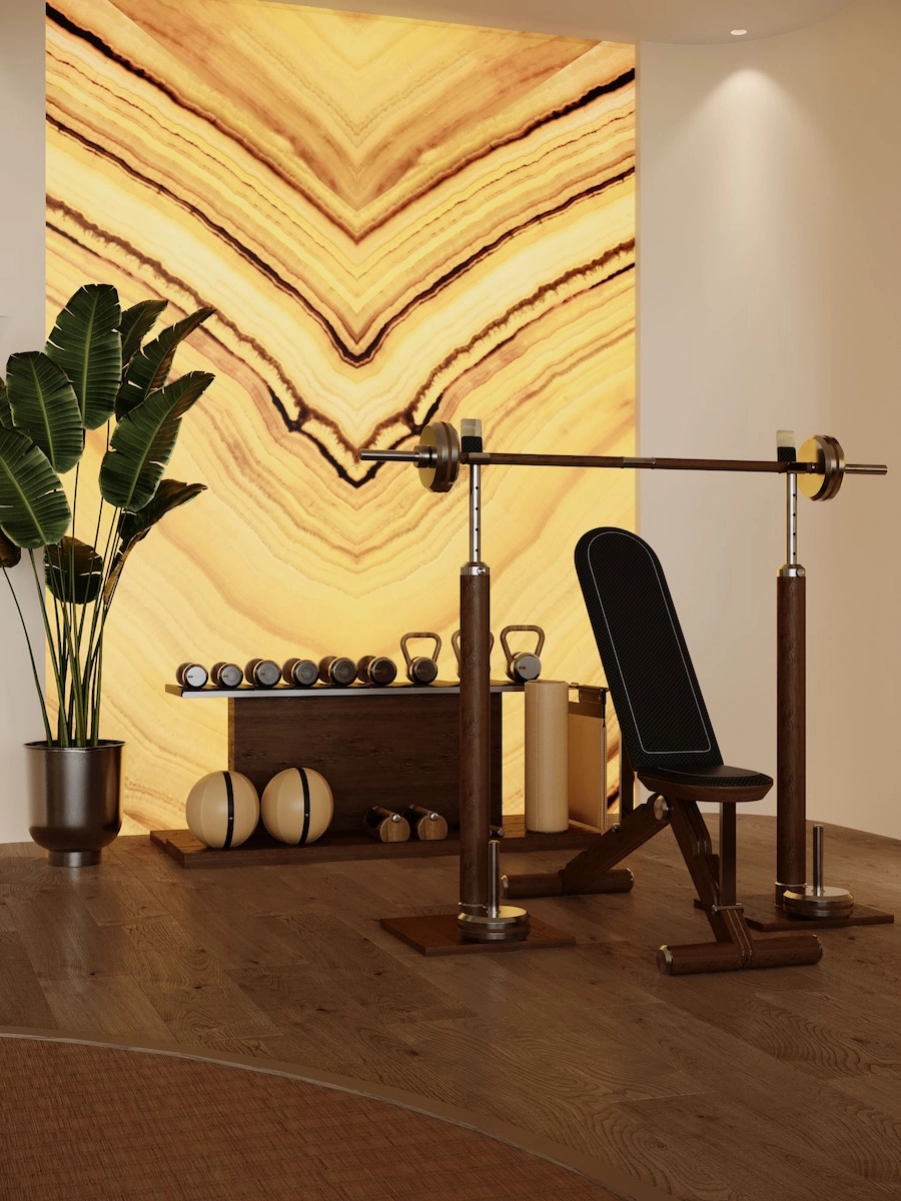Espace musculation privé à Monaco avec banc design, haltères, matériaux nobles et architecture intérieure haut de gamme sur mesure.
